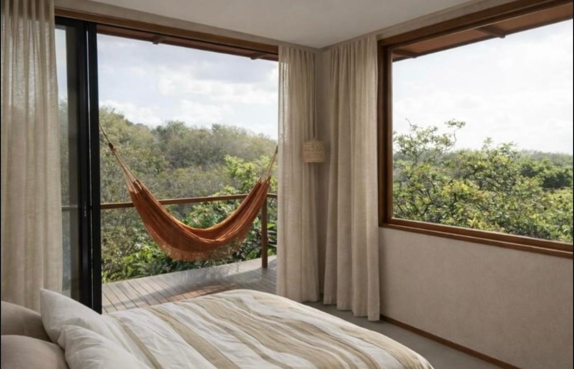 Quarto com rede e vista para a mata
